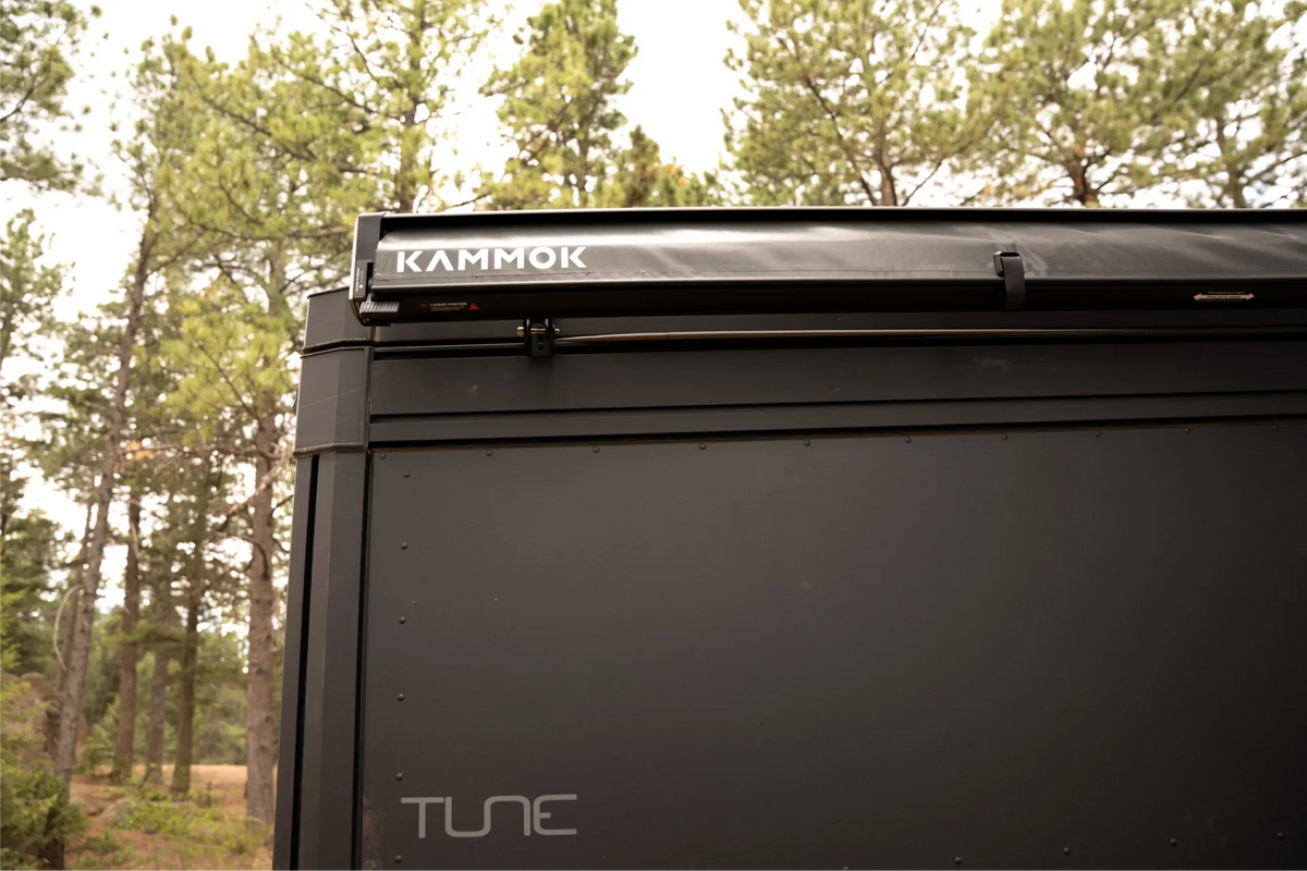 Black truck bed with 'Kammor' and 'Tune' branding against a forest background