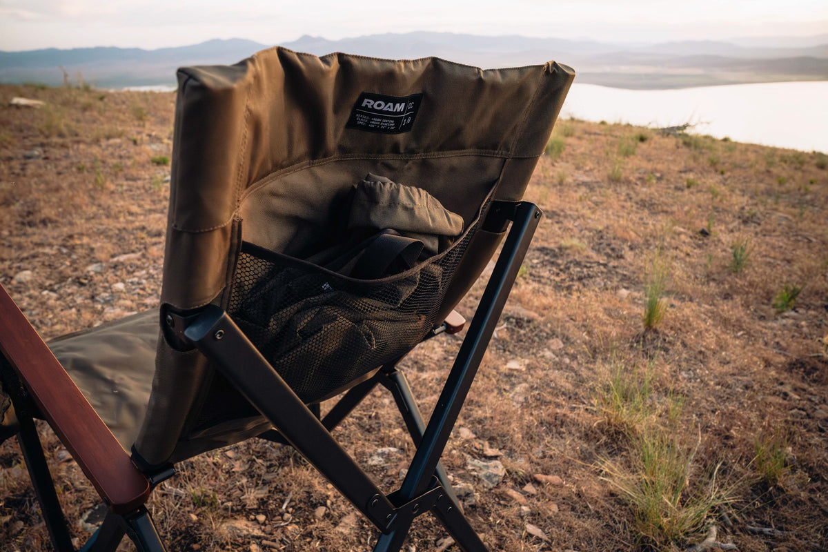 Brown camping chair with black legs in a desert landscape
