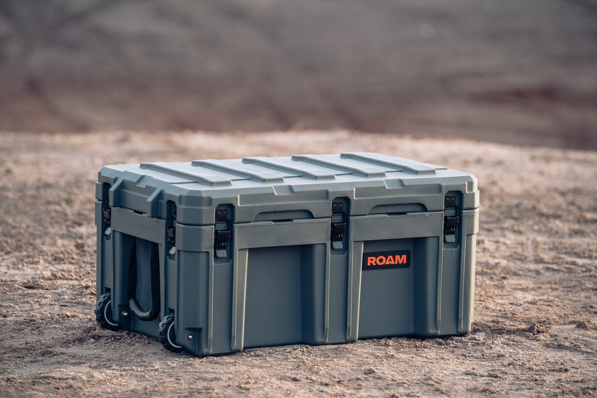 Gray storage case with 'ROAM' branding on a desert background