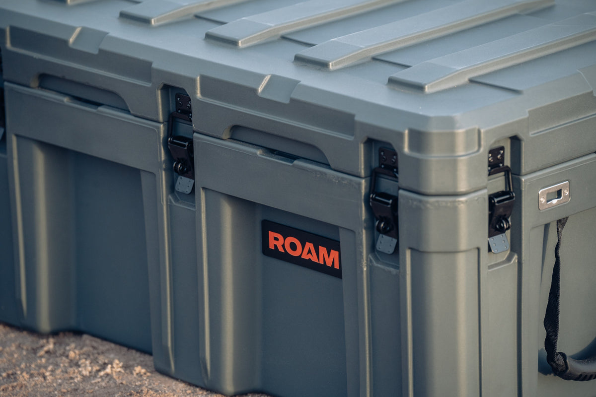 Gray storage case with 'ROAM' logo on a textured surface